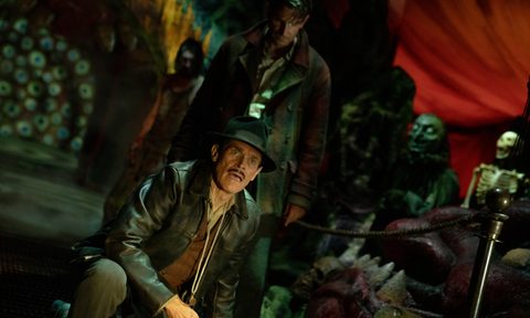 Bradley Cooper creeps up behind Willem Dafoe — just two of the star-studded cast in Guillermo del Toro's "Nightmare Alley."
