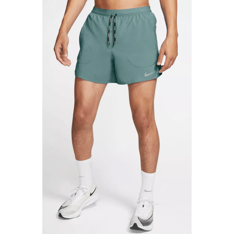 A midsection wearing the Nike Flex Stride and a pair of Nike shoes.