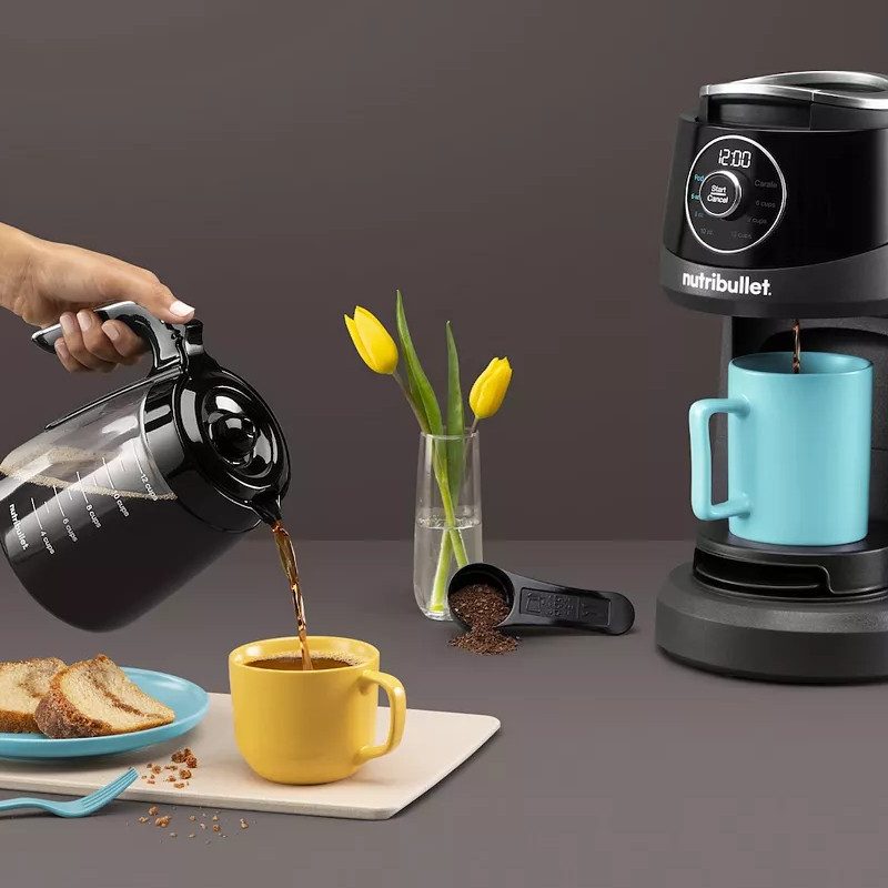 Nutribullet Brew Choice Pod with a person using the carafe serving coffee with breakfast food on the table.