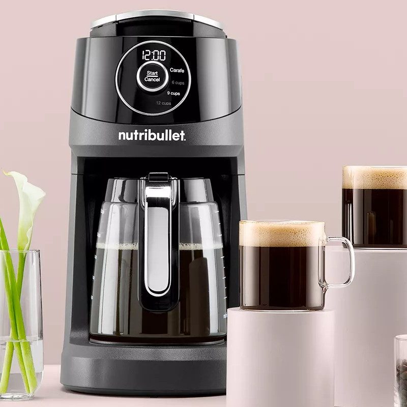 Nutribullet Brew Choice Pod + Carafe Coffee Maker with two coffee cups on the side and whole coffee beans.