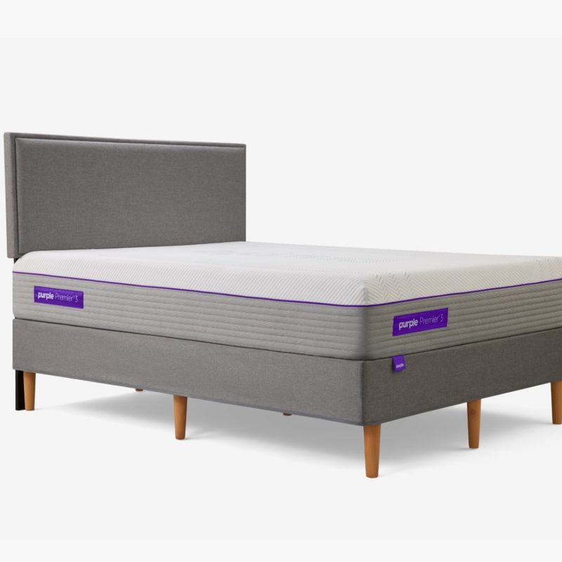 A Purple Premier Hybrid 3 Mattress on a bed on plain background