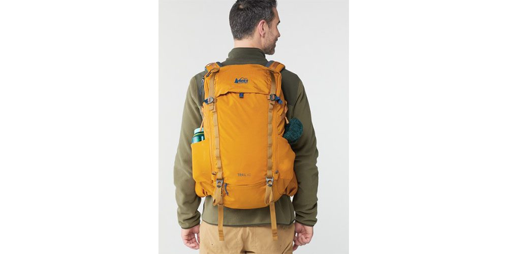 REI Co-op Trail 40 Pack worn by a man on a white background.