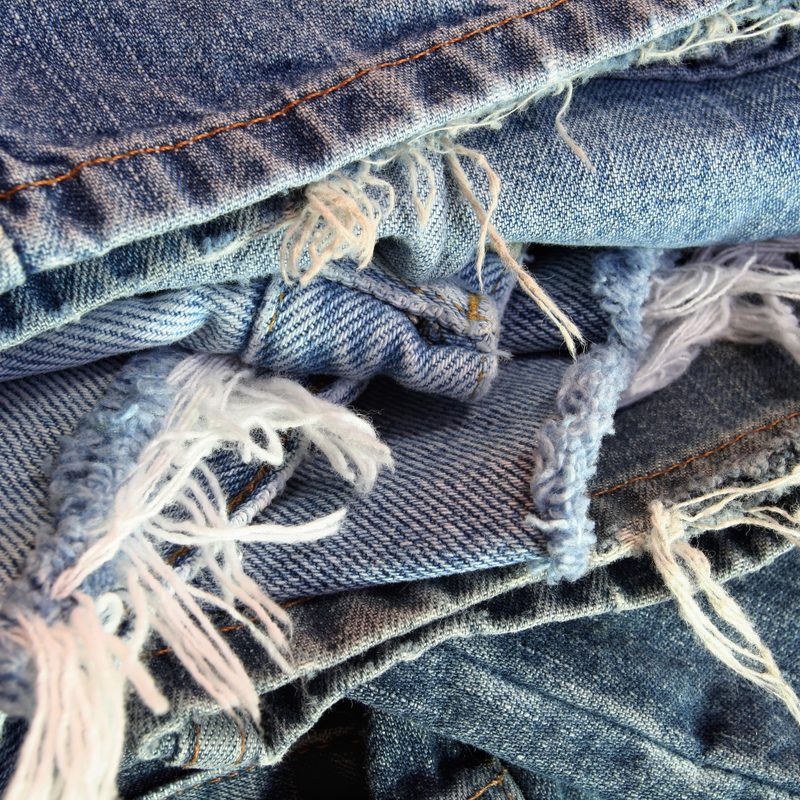 A pile of ripped denim jeans.