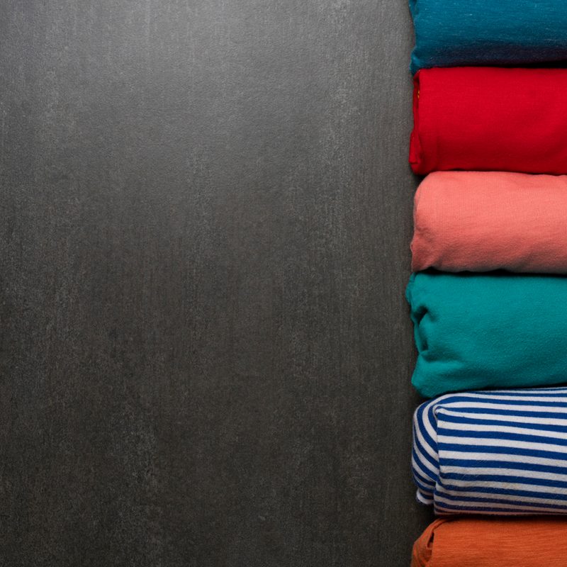 Rolled clothes on a wooden table.
