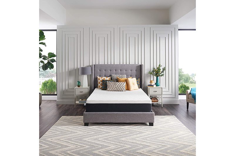 Sealy To Go memory foam mattress on an upholstered bed.