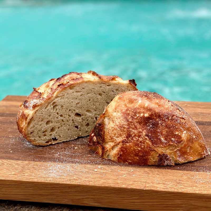 Two slices of sourdough on a wooden cutting board.