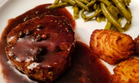 steak with beurre rouge sauce, potatoes, and green beans.