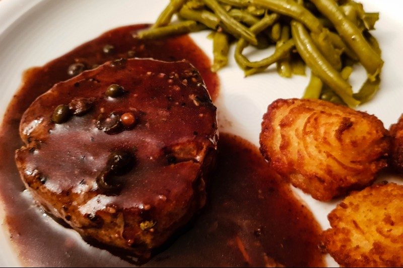 steak with beurre rouge sauce, potatoes, and green beans.