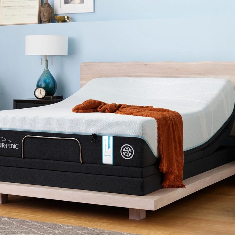 A Tempur-Breeze on a bed frame in a bedroom.