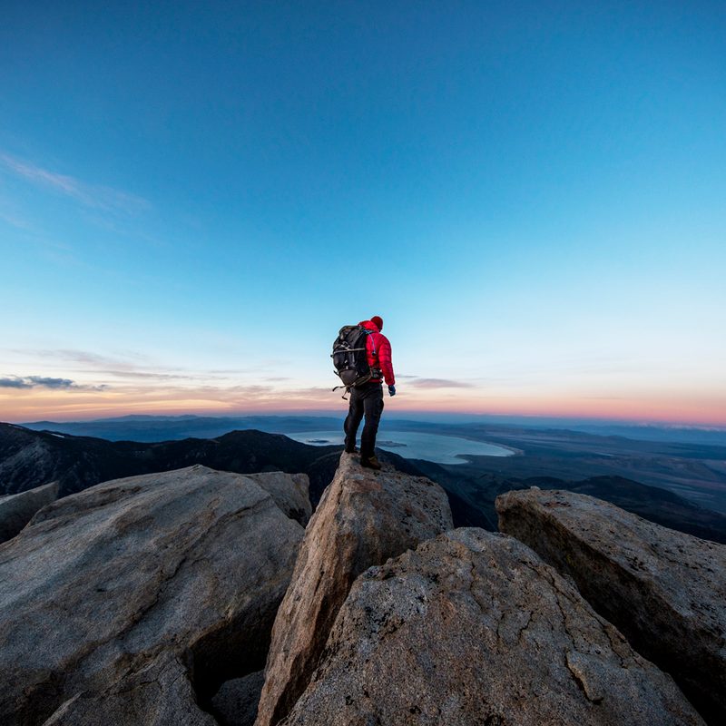 A male hiker standing on the summit