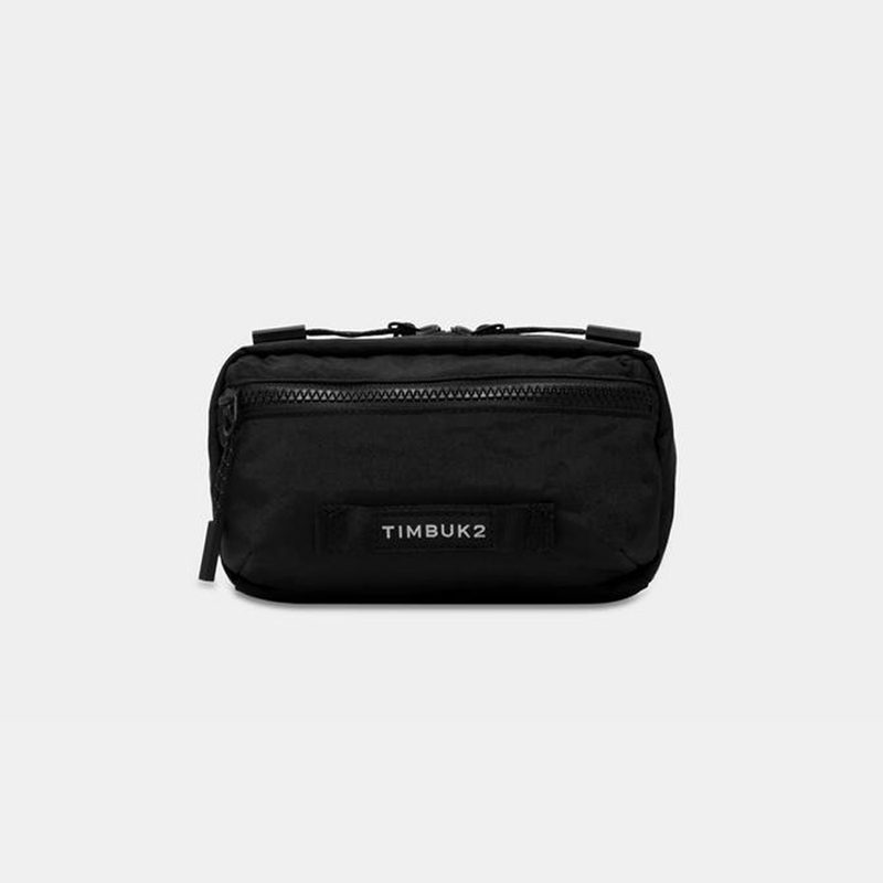A black Timbuk2 Rascal Belt Bag on gray background.