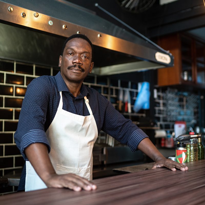 A barista posing behind the counter.