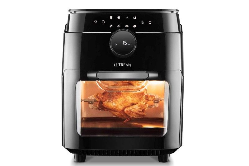 An Ultrean Air Fryer Oven cooking a whole chicken.