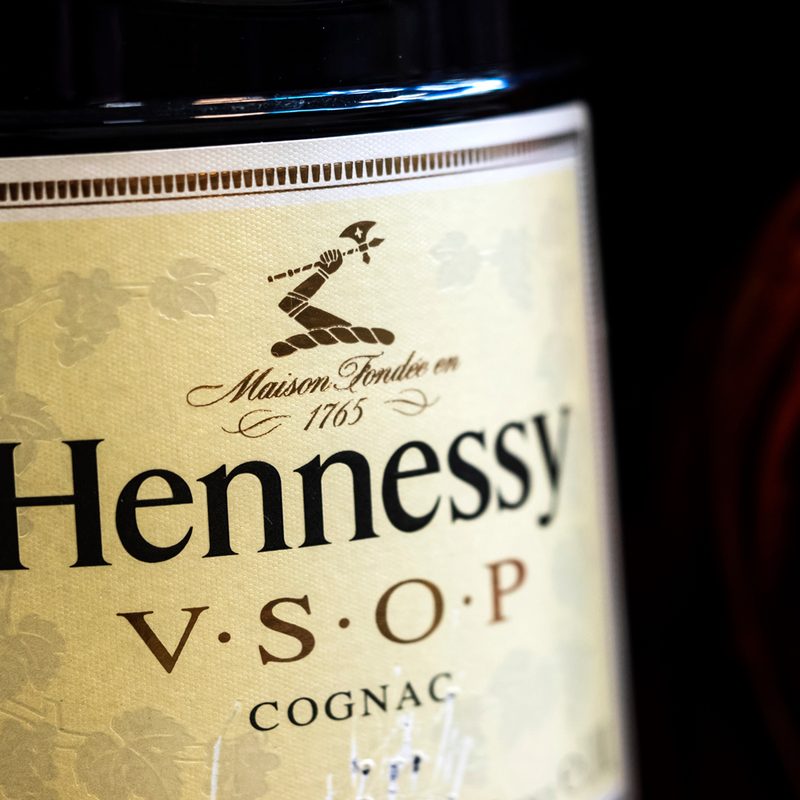 A close-up of a bottle of Hennessy V.S.O.P Cognac in a store.