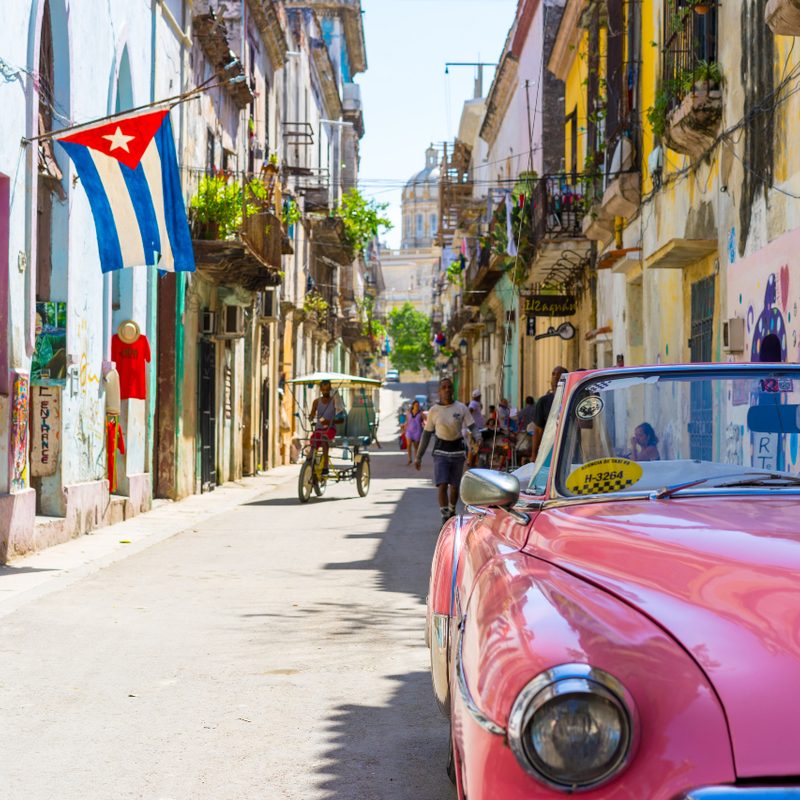 Vintage car and Cuban Flag in Cuba.