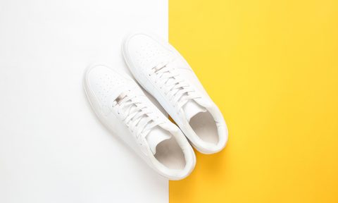 White sneakers on a white and yellow background.