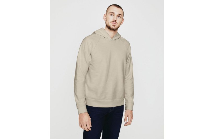 A male model wearing an AG Jeans Curry Pullover Hoodie and pants.