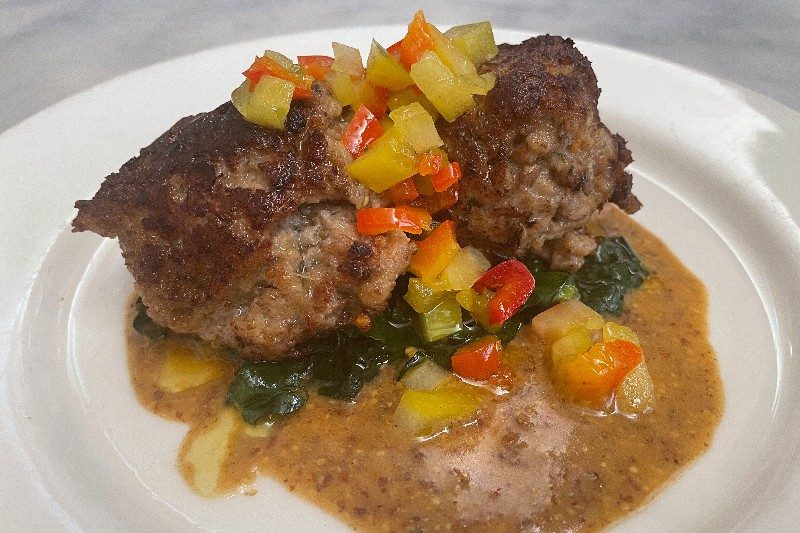Little Dom's Alligator Meatballs served on a white plate.
