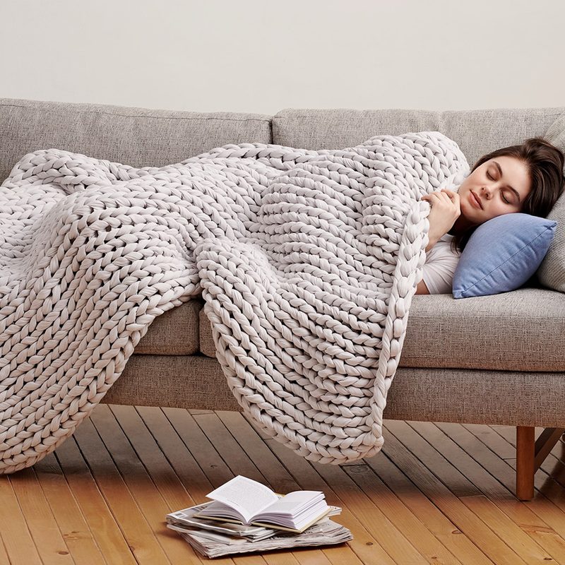 Bearaby Tree Napper weighted blanket on sleeping woman.