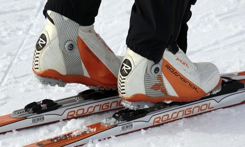 A person with ski boots on a ski.