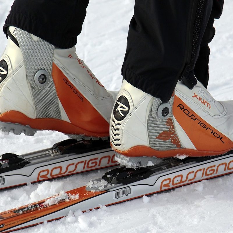 A person with ski boots on a ski.