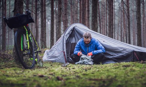Camper sitting outside his tent
