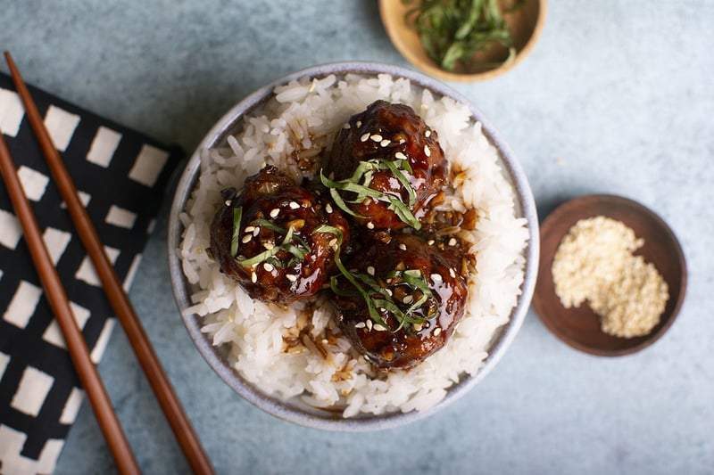 Cambodian lemongrass curry meatballs in a bowl with chopsticks.