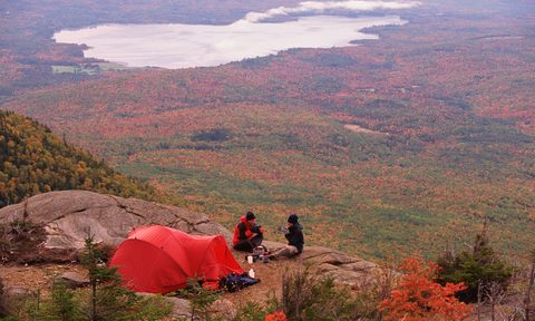 Couple sitting in campsite in fall.