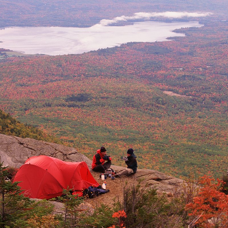 Couple sitting in campsite in fall.