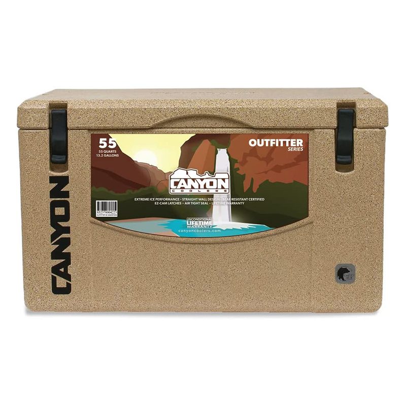 A brown Canyon Coolers Outfitter Rotomolded Cooler with a sticker of the brand on it.