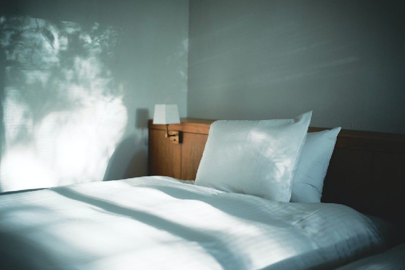 Fluffy bed that's neatly made.