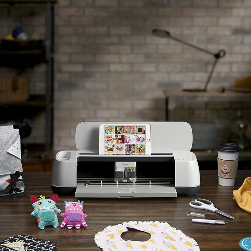 Cricut Maker on a wooden desk.