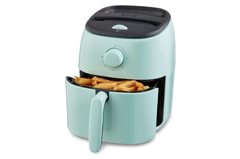 Dash electric Tasti Crisp Air fryer with fries.
