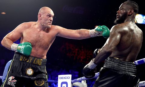 Tyson Fury punching Deontay Wilder.