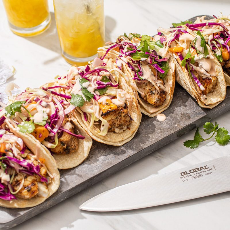 A Global knife beside an appetizing dish on a table.