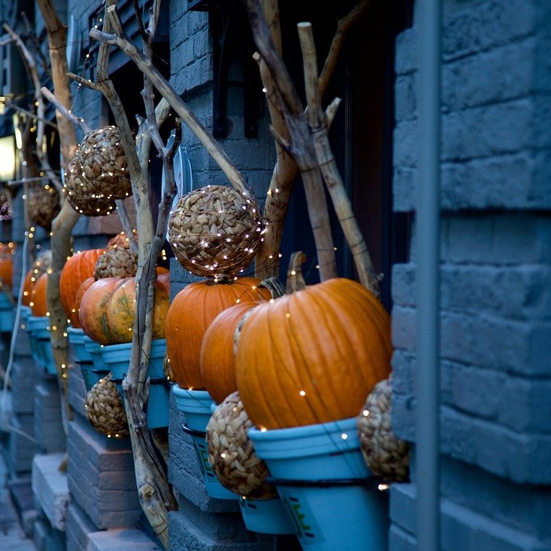 pumpkin decor outside a building.