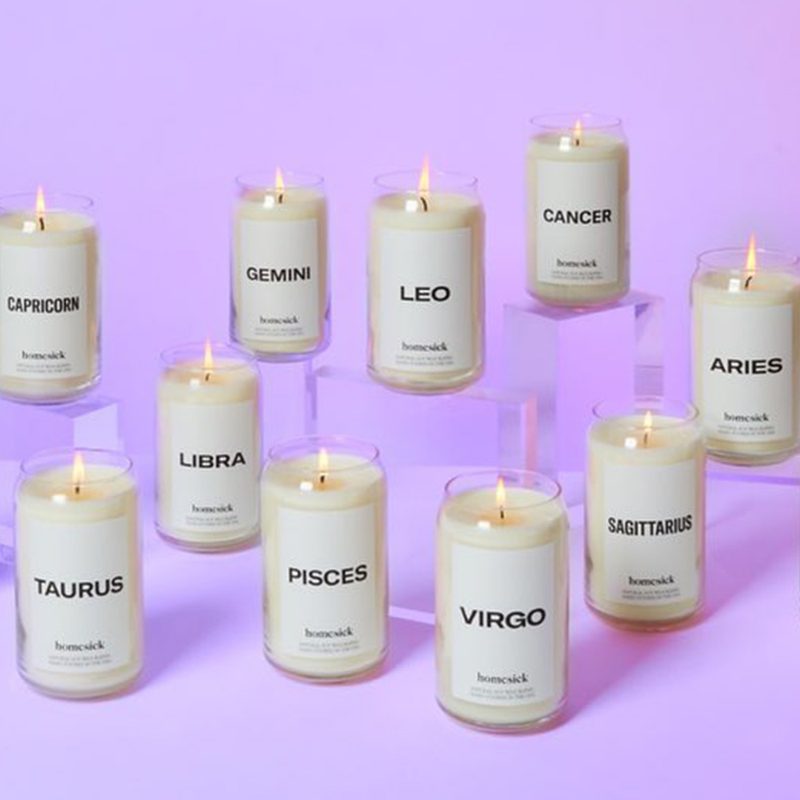 Homesick Candles Astrology Collection on purple background.