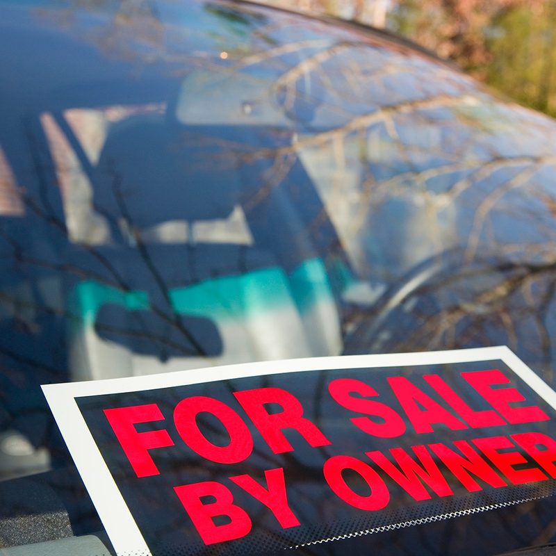 For Sale by Owner sign on car.
