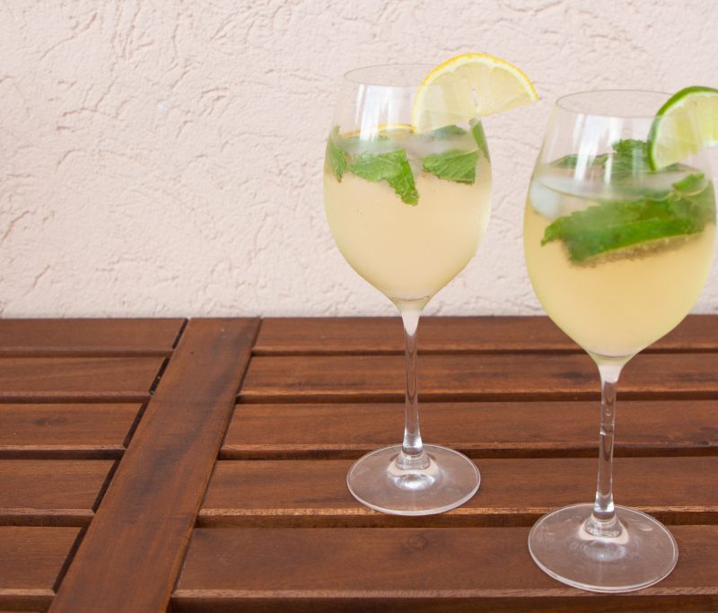 Hugo cocktail in white background.