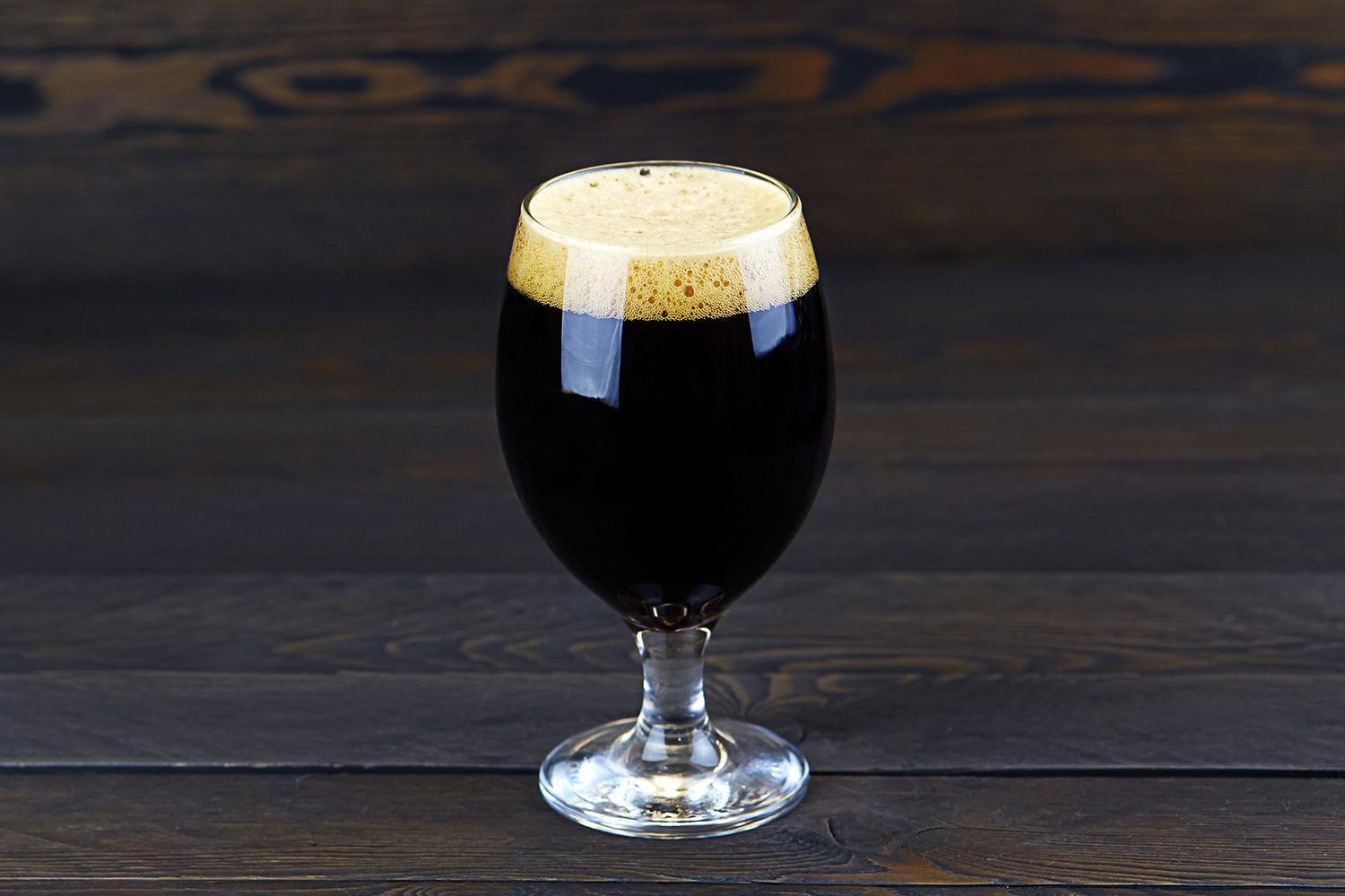 An imperial stout in a tulip beer glass.