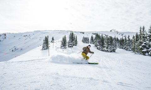 Skier on powdery slope.