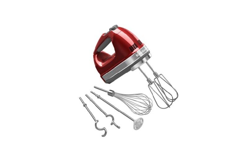 Red KitchenAid hand mixer with accessories.