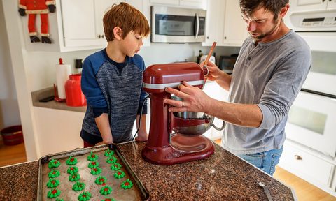 Father and son baking cookies.