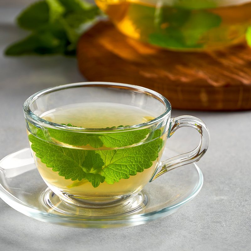 Fresh natural melissa , lemon balm herbal tea in glass cup.