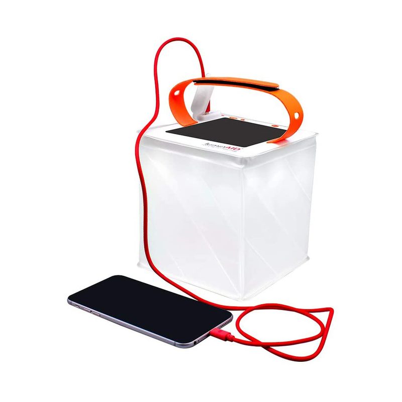 A LuminAid PackLite Titan 2-in-1 Camping Lantern charging a phone.