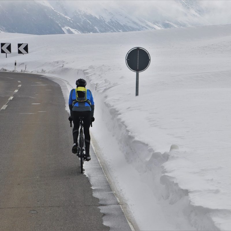 Man cycling in snowy conditions.