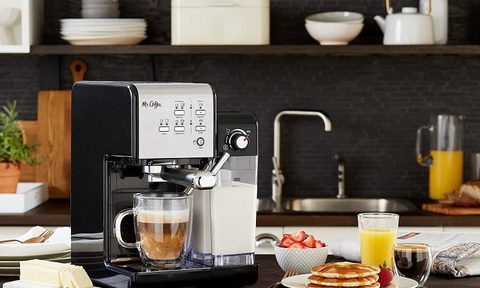 Mr Coffee one touch espresso maker in a kitchen setting with breakfast dishes.
