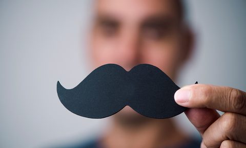 Young man with a fake moustache.