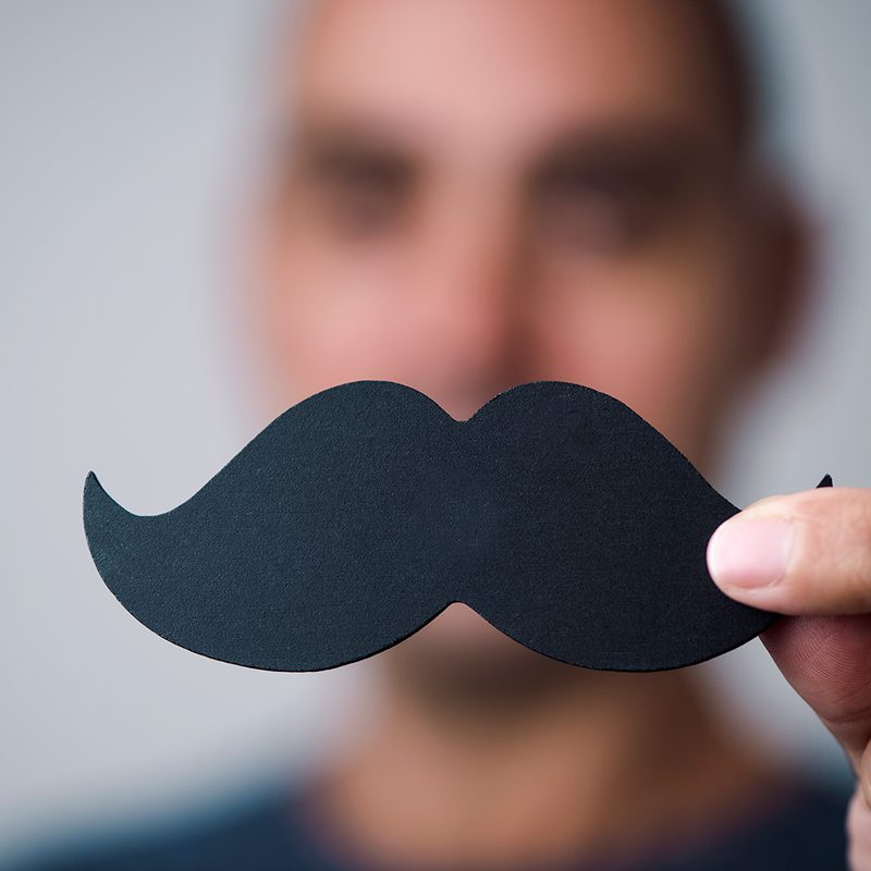 Young man with a fake moustache.