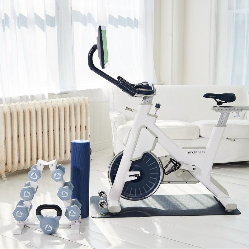 MYX II Plus stationary Star Trac bike with weights in white color.